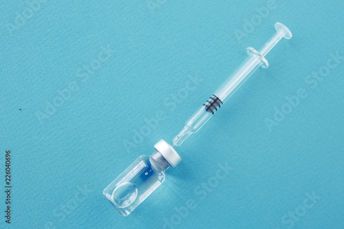 Medical glass vials and syringe for vaccination. liquid drug or vaccine for treatment, flu in laboratory, hospital or pharmacy concept