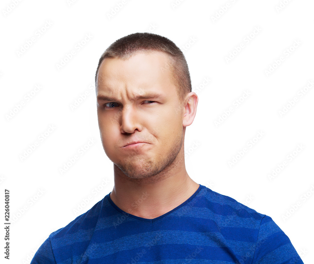portrait of a handsome young man disliking something portrait of a handsome young man disliking something