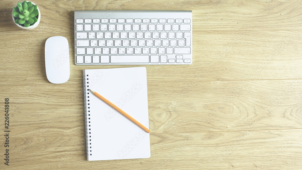 Computer keyboard, mouse and notebook with a pencil on the table Computer keyboard, mouse and notebook with a pencil on the table