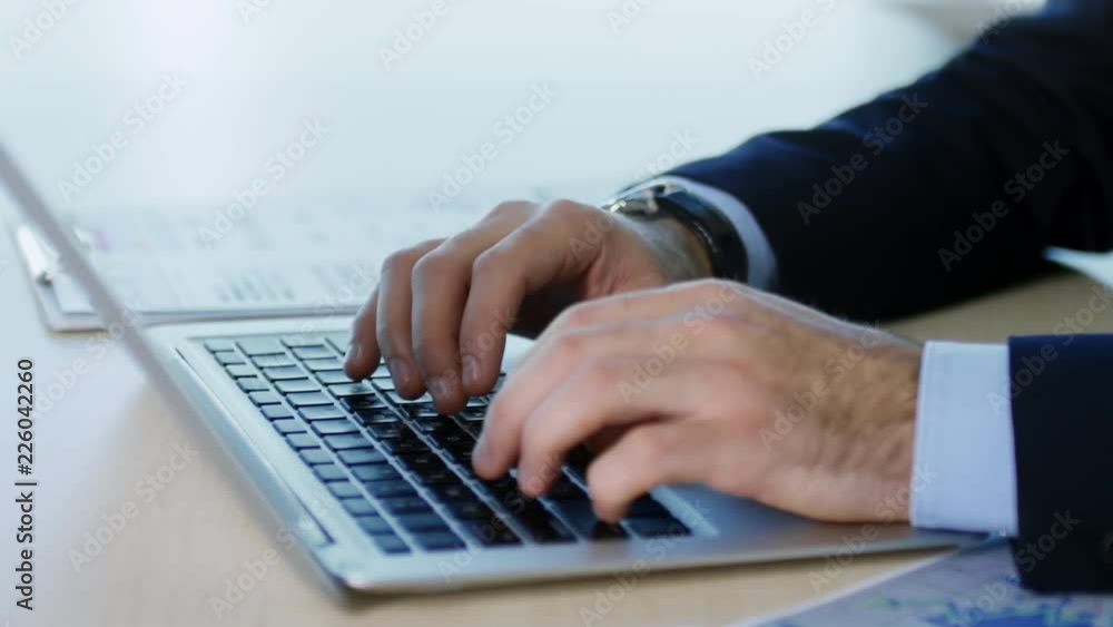 Close up hands of unrecognizable businessman using laptop computer for work when sitting at desk, tracking shot Close up hands of unrecognizable businessman using laptop computer for work when sitting at desk, tracking shot