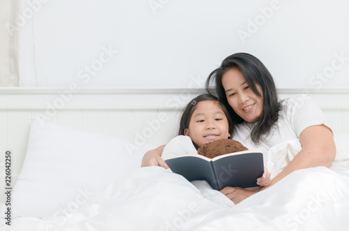 Mother read book with daughter