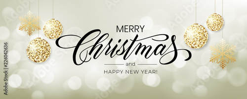 Merry Christmas background with blur bokeh light effect. Lettering Merry Christmas and Happy New Year