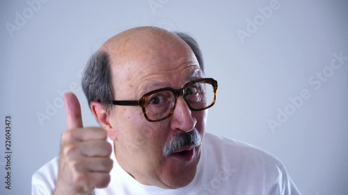 happy excited facial emotion expression of senior 60 70 year old man using large framed comical glasses overwhelmed after seeing a very good product on sale in face expression concept .