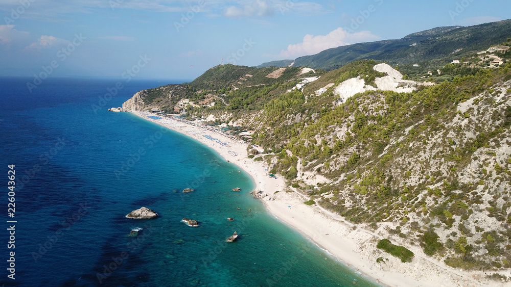 Aerial drone bird's eye view photo of popular beach of Milos with turquoise clear waters and sun beds, island of Lefkada, Ionian, Greece Aerial drone bird's eye view photo of popular beach of Milos with turquoise clear waters and sun beds, island of Lefkada, Ionian, Greece