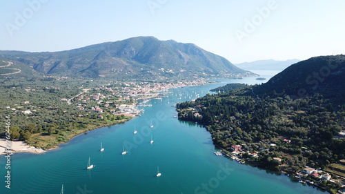 Aerial drone bird's eye view photo of iconic port of Nidri or Nydri a safe harbor for sail boats and famous for trips to Meganisi, Skorpios and other Ionian islands, Leflkada island, Ionian, Greece © aerial-drone