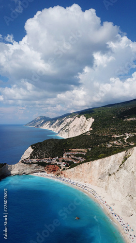 Aerial drone photo of popular tropical paradise deep turquoise beach of Porto Katsiki with white steep rocky seascape and beautiful cloudy landscape, Lefkada island, Ionian, Greece © aerial-drone