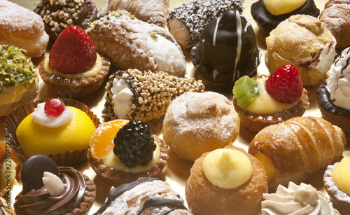 many kind of little pastries with cream, chocolate and fruit
 photo