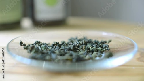 Tea leaves and flowers poured on a saucer - the art of beautiful tea