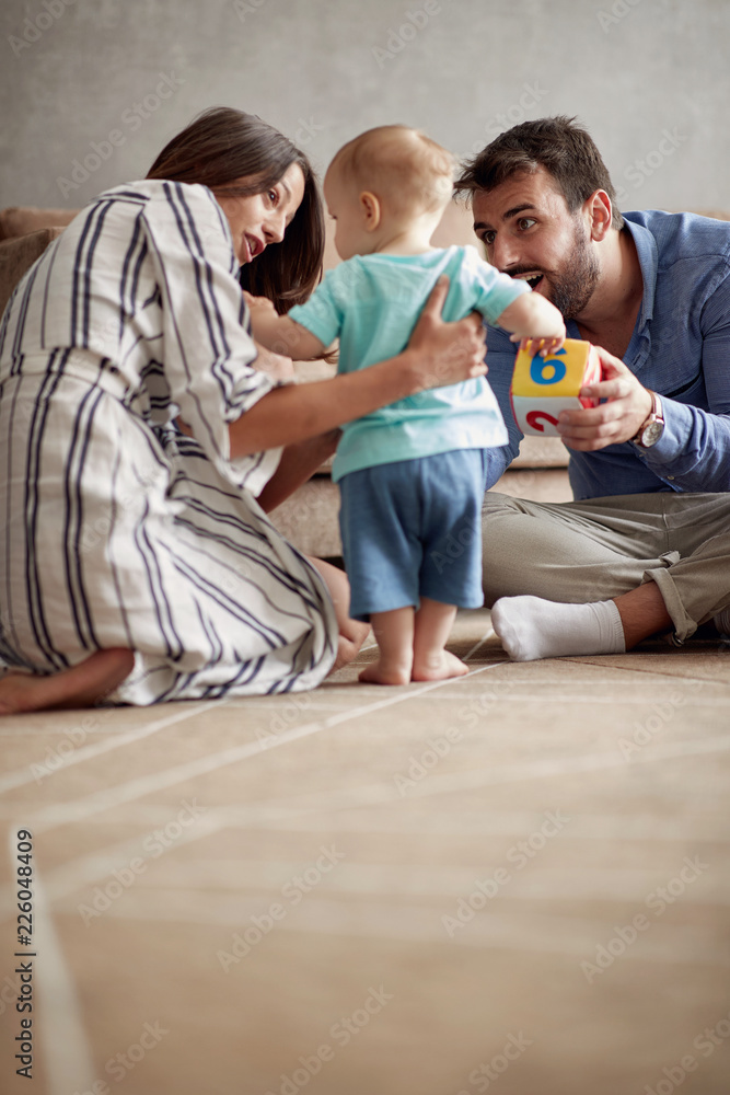 happy loving family. mother and father playing with her baby at home. happy loving family. mother and father playing with her baby at home.