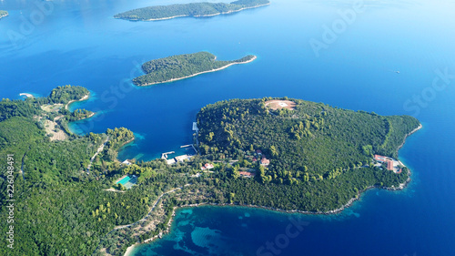 Aerial drone bird s eye view panoramic photo of iconic island of Skorpios that was owned by Aristotle Onasis and port of Nidri at the background  Lefkada island  Ionian  Greece