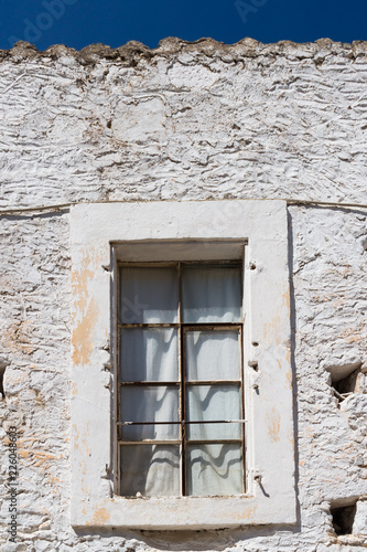 Window and a white stone wall, Greece