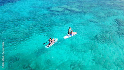 Obraz na plátně Aerial drone photo of couples practicing Stand Up Paddle or SUP in famous waters