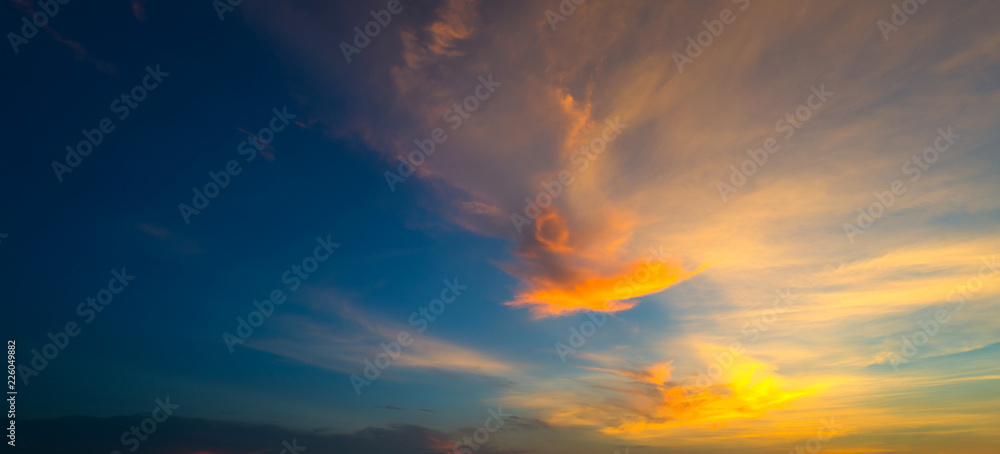  Sunlight with dramatic sky. Cumulus sunset clouds with sun setting down on dark background.orange and dark cloud sky.