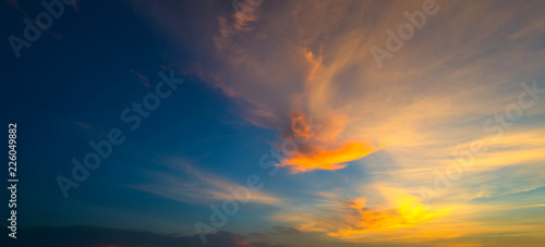  Sunlight with dramatic sky. Cumulus sunset clouds with sun setting down on dark background.orange and dark cloud sky.