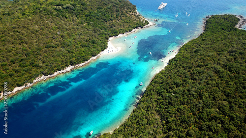 Aerial drone bird's eye view photo of iconic paradise sandy beach of blue lagoon with deep turquoise clear sea and pine trees in complex island of Mourtos in Sivota area, Epirus, Greece