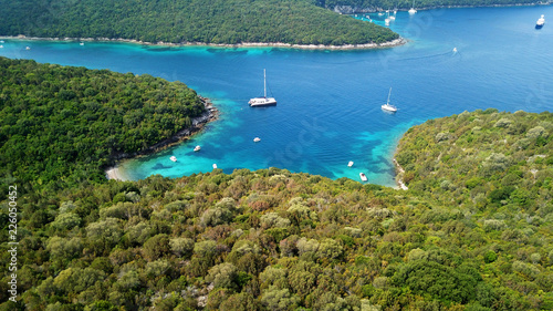 Fototapeta Naklejka Na Ścianę i Meble -  Aerial drone bird's eye view photo of iconic paradise sandy beach of blue lagoon with deep turquoise clear sea and pine trees  in complex island of Mourtos in Sivota area, Epirus, Greece