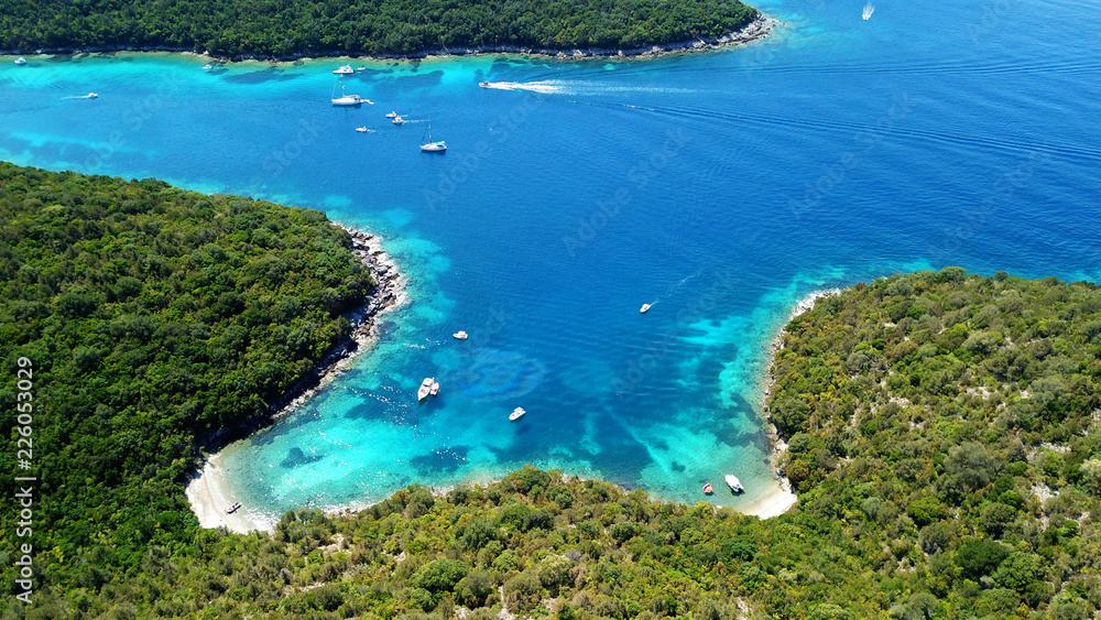 Aerial drone bird's eye view photo of iconic paradise sandy beaches with turquoise sea in complex islands of Agios Nikolaos and Mourtos in Sivota area, Ionian sea, Epirus, Greece