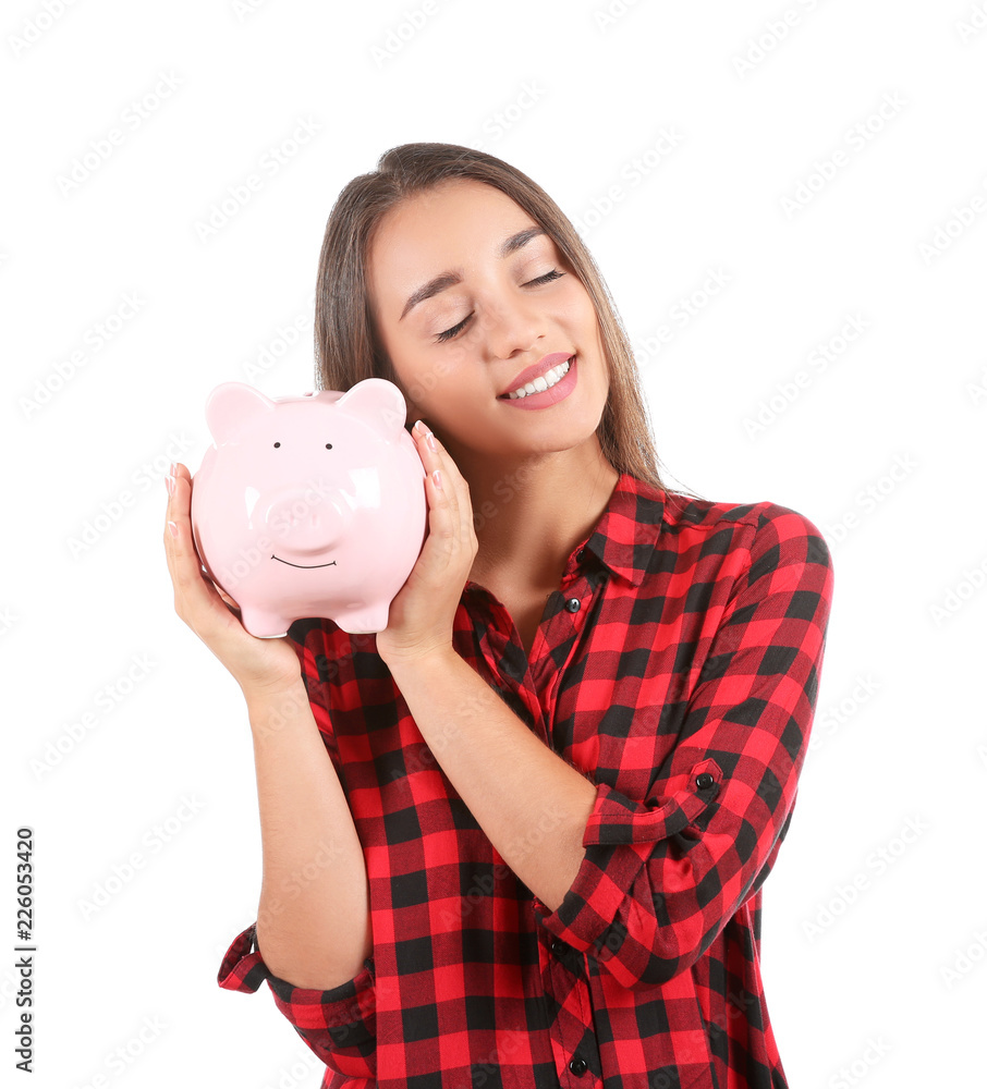 Young woman with piggy bank on white background Young woman with piggy bank on white background