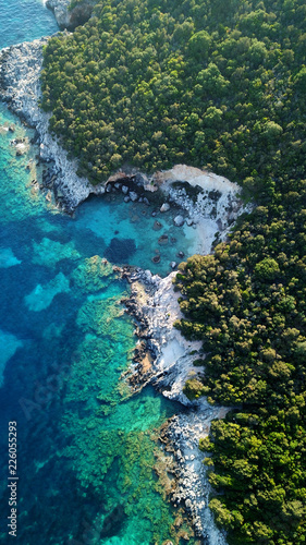 Aerial photo of tropical exotic paradise vegetated island with blue lagoon, white rocky beaches and turquoise sea