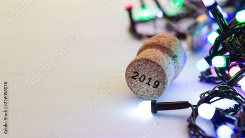 Champagne cork on table with christmas lights