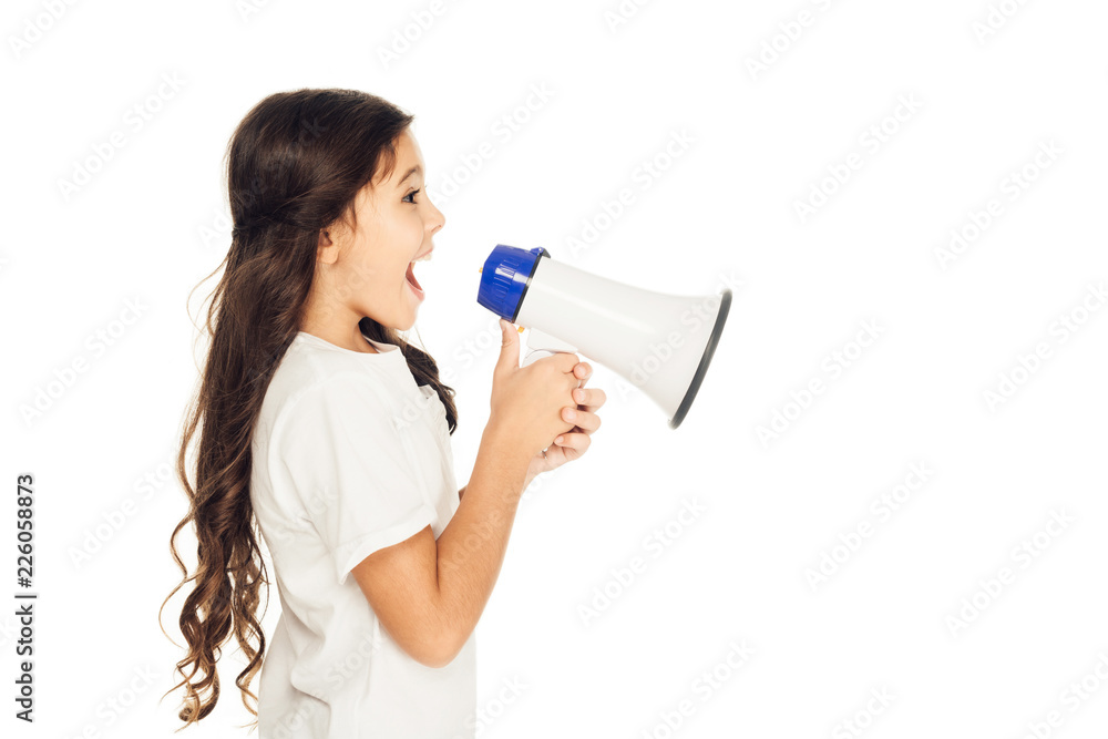 side view of happy child holding megaphone and looking away isolated on white side view of happy child holding megaphone and looking away isolated on white