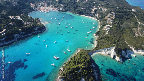 Aerial drone bird's eye view photo of iconic small port and fishing village of Lakka with traditional Ionian architecture and sail boats docked, Paxos island, Ionian, Greece photo