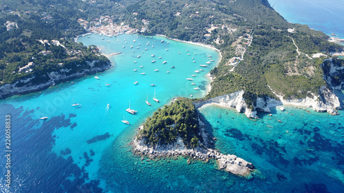 Aerial drone bird's eye view photo of iconic small port and fishing village of Lakka with traditional Ionian architecture and sail boats docked, Paxos island, Ionian, Greece