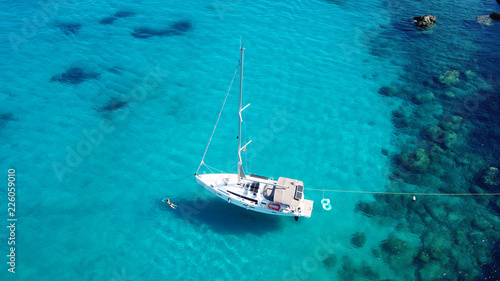 Aerial drone top view photo of luxury sail boats docked in tropical bay with turquoise and emerald clear sea © aerial-drone