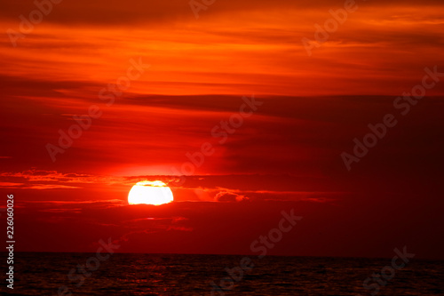 last light sunset on  sky orange cloud ray around sun over sea