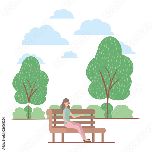 young woman seated in chair on the park