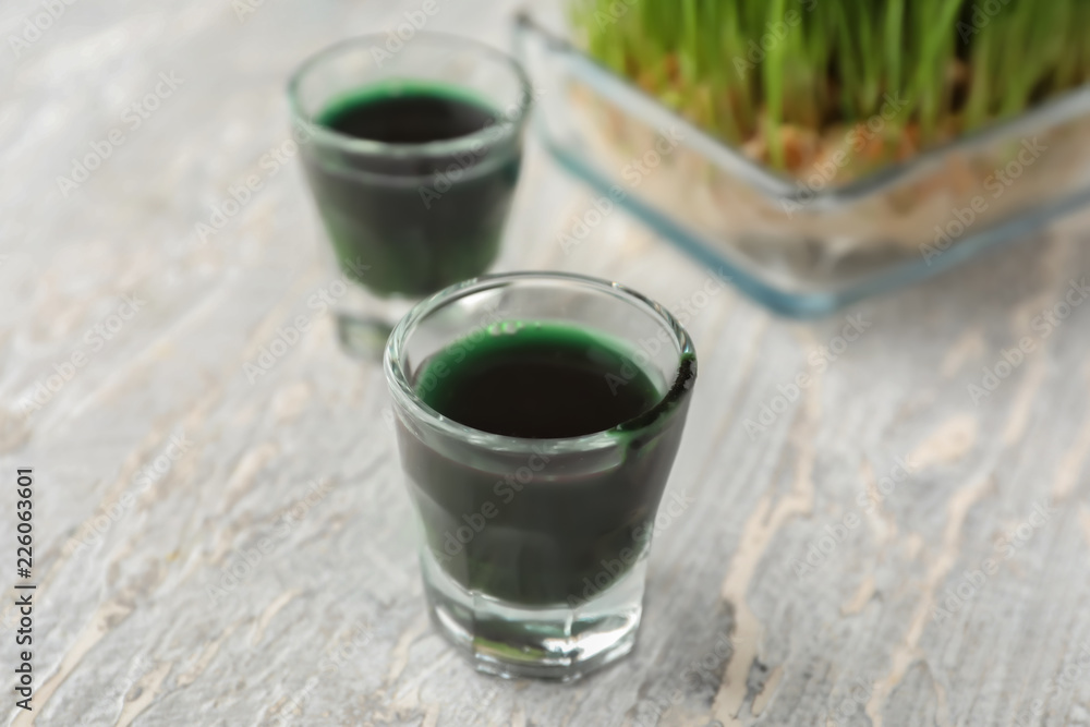 Glasses of fresh wheat grass juice on table Glasses of fresh wheat grass juice on table