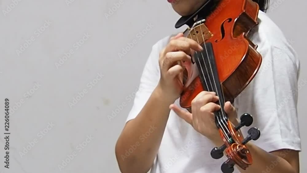 The lady is showing technique of Pizzicato on string,playing by plucking strings with fingers The lady is showing technique of Pizzicato on string,playing by plucking strings with fingers