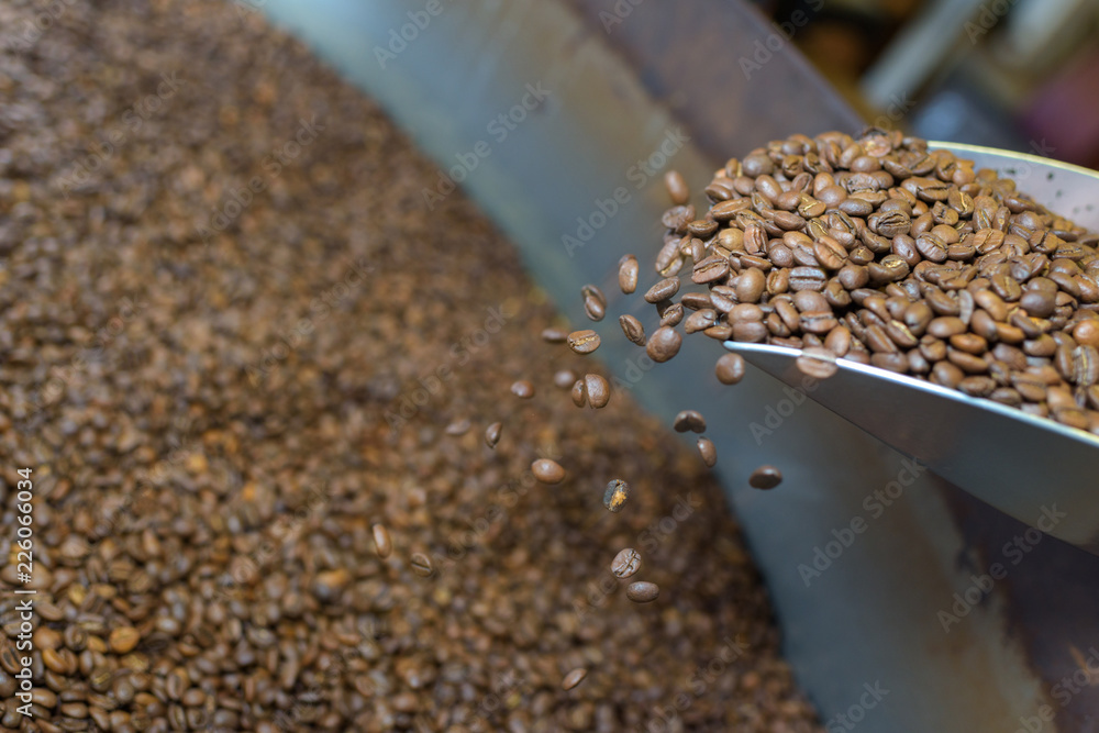 coffee beans being poured into pan coffee beans being poured into pan