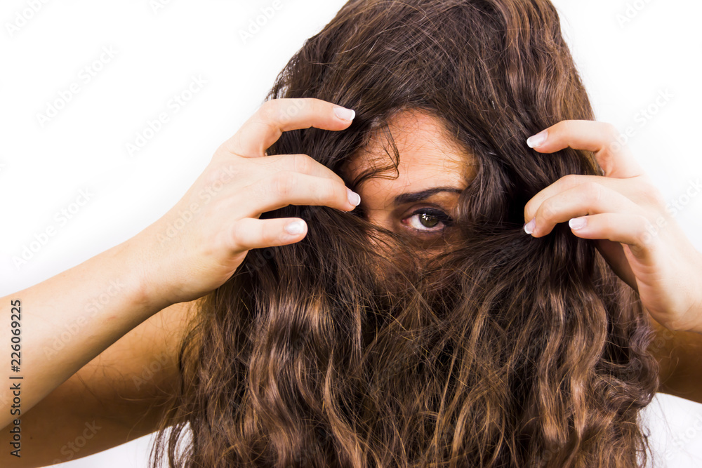 Beautiful woman removing her hair from her face on white background Beautiful woman removing her hair from her face on white background