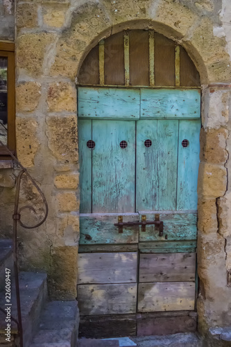 Old light blue wooden door with steps © REDMASON