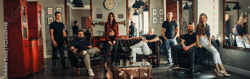 Φωτογραφία Team from seven barbers in modern barbershop.