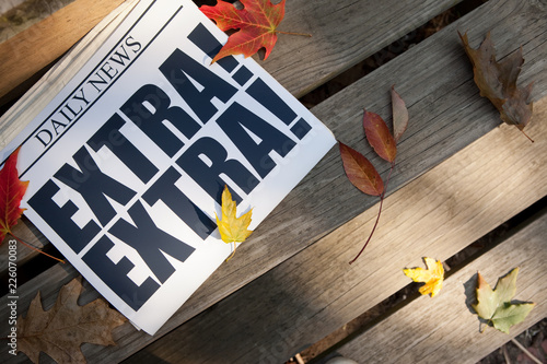 Принти на полотні Extra! Newspaper on Deck with Autumn Leaves