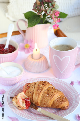 breakfast with coffee and croissant on porcelain in pink