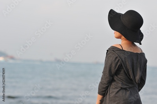 Emotional portrait of Fashion stylish portrait of pretty young hipster asian woman posing on the beach. hat, swimsuit, outdoor fashion portrait ,going crazy,elegant black hat cool © tpap8228