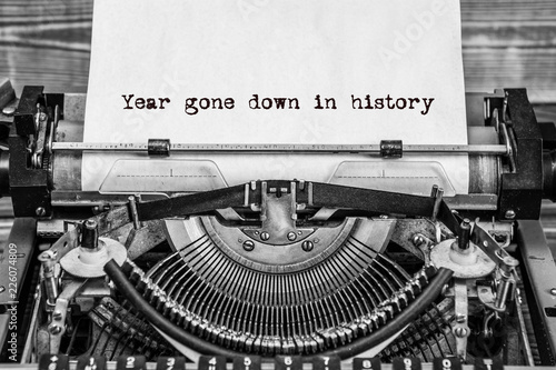 year gone down in history, text on a vintage typewriter, in black ink on old paper.