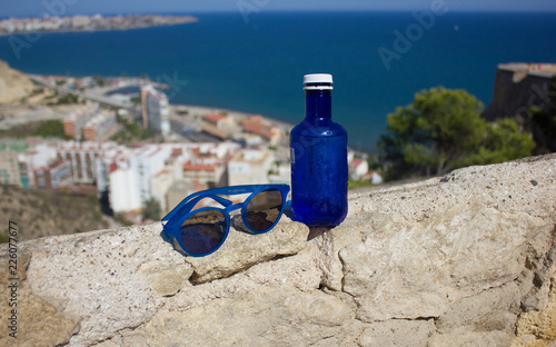 water in a bottle, sunglasses, a magnificent view at the sea, Spain of Alicante