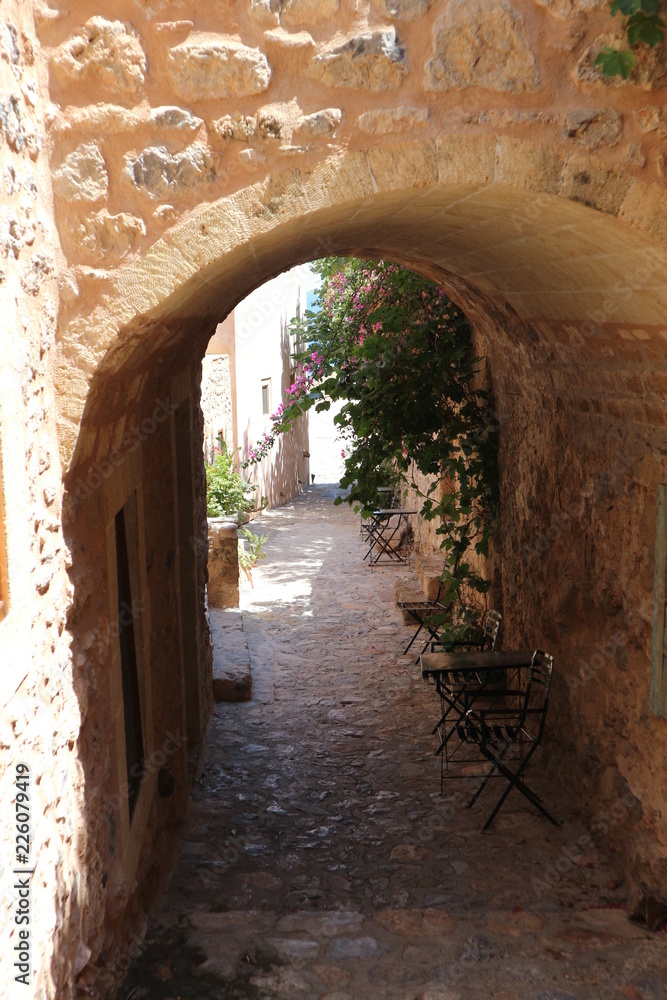 Obraz premium Old arch on narrow medieval street of Monemvasia, Peloponnese, Greece
