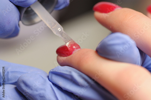 Professional manicure process in beauty salon.