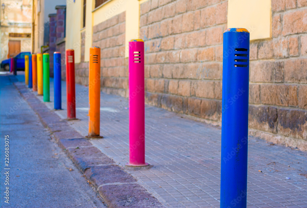 barrier made with colored poles in an alley