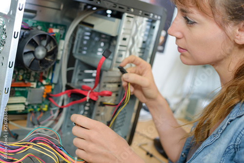 Young lady rewiring computer
