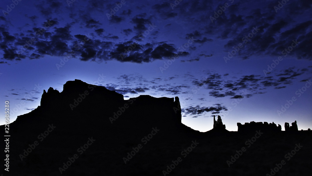 Silhouettes of mountains on a desert at dawn
