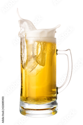 Cold beer splash out of mug isolated on white background.