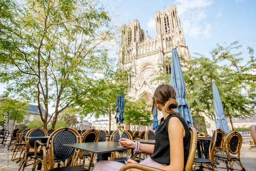 Woman with a glass of champagne in Reims, France