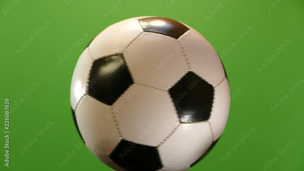 The soccer ball is spinning on a green background. Sports game Soker. Champions League. World Championship. Goal to the gate. The soccer ball is spinning on a green background. Sports game Soker. Champions League. World Championship. Goal to the gate.