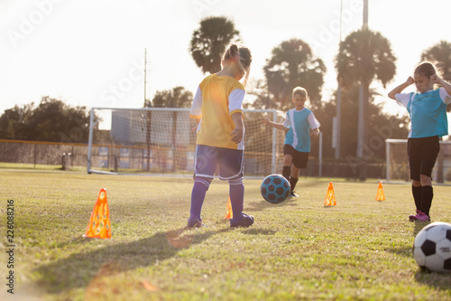 Soccer players practicing on a field.